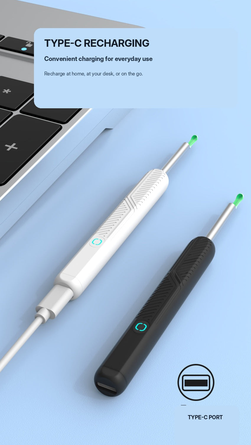 White and black ear cleaners with Type-C charging cable beside a laptop
