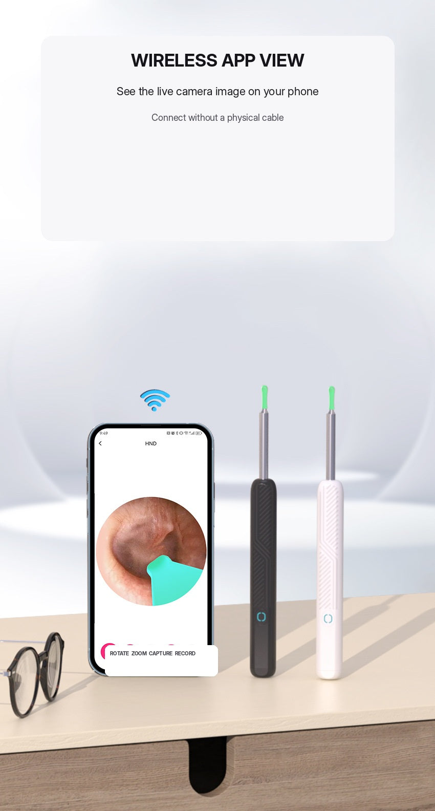 Phone showing live ear camera image with wireless connection beside black and white ear cleaners